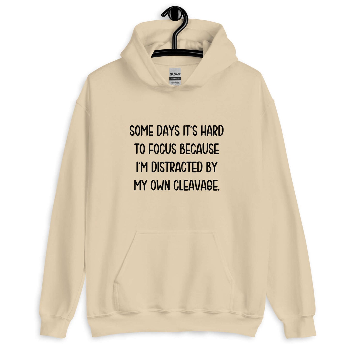 Sand hoodie sweatshirt with the phrase Some days it's hard to focus because I'm distracted by my own cleavage printed on the front.