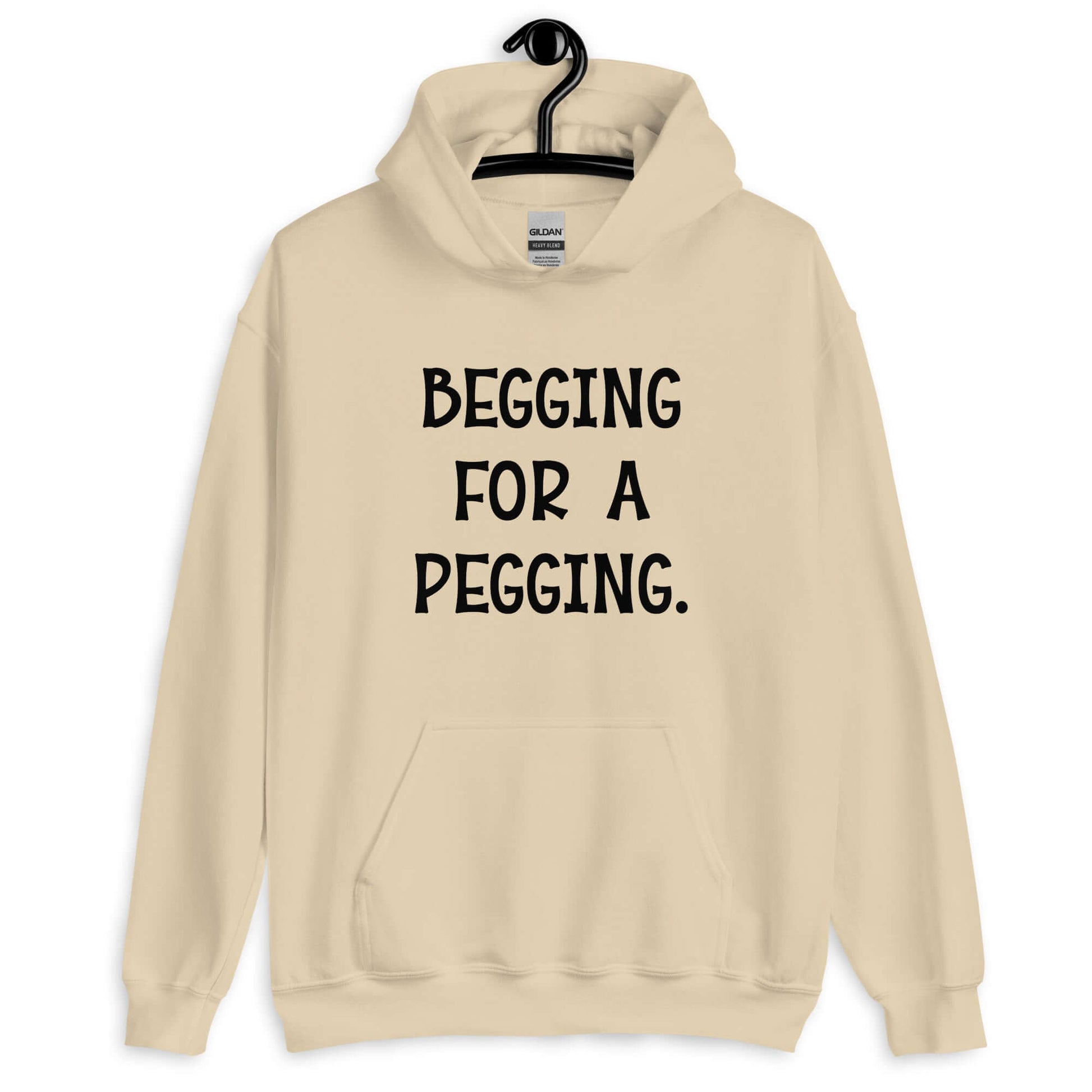 Sand hoodie sweatshirt with the words Begging for a pegging printed on the front.