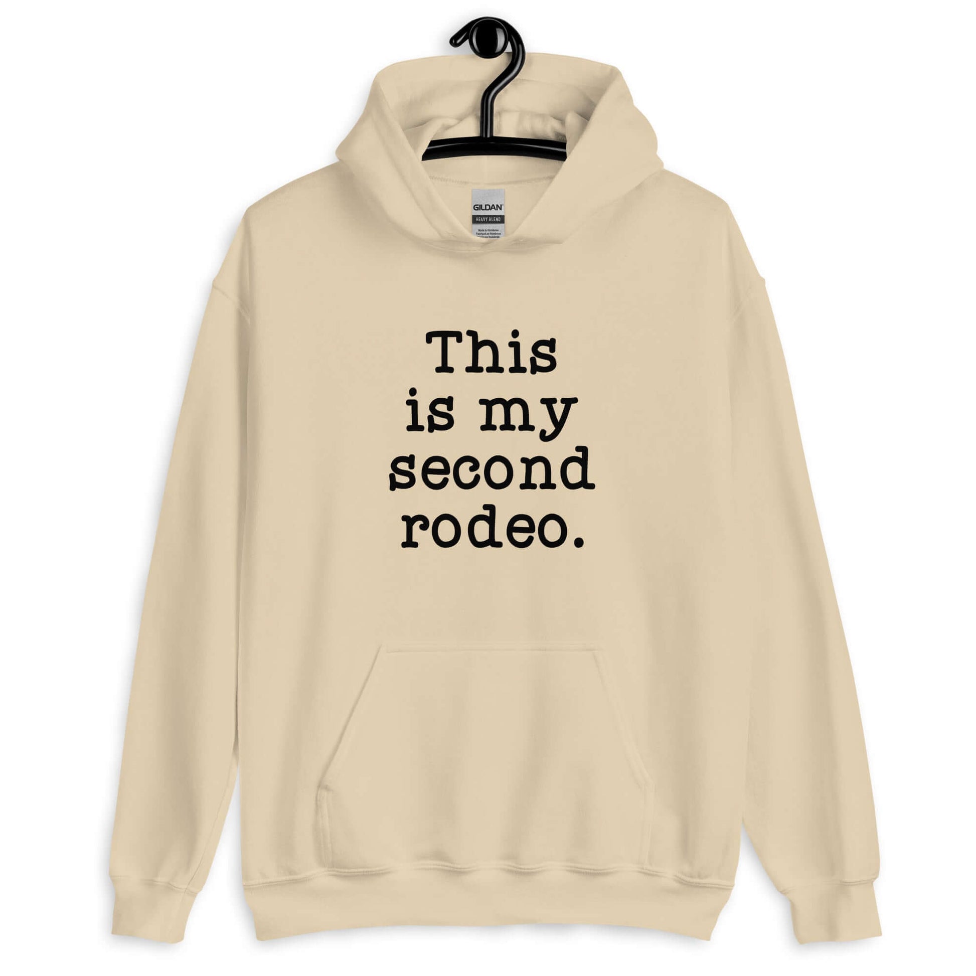 Sand hoodie sweatshirt with the funny phrase This is my second rodeo printed on the front.