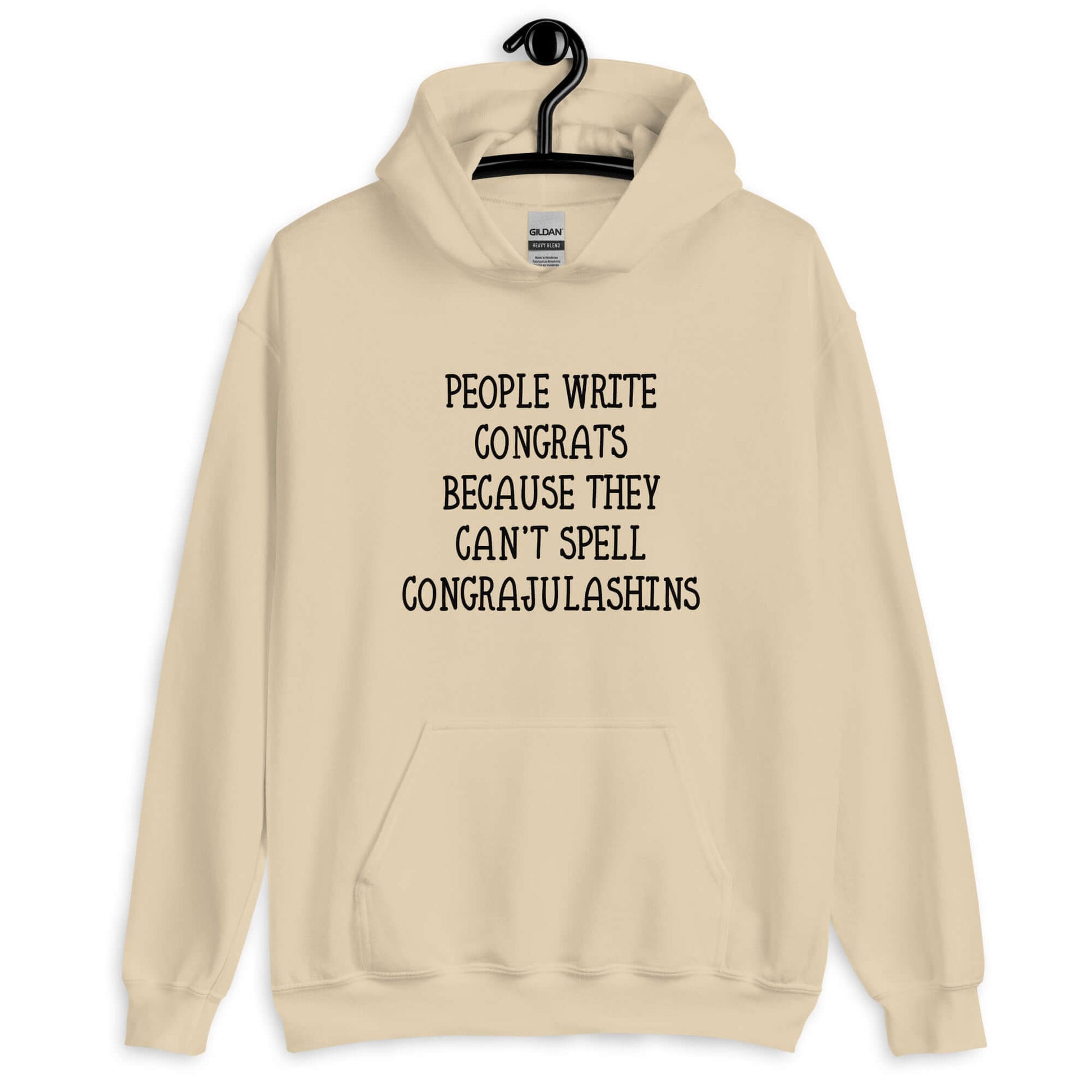 Sand hoodie sweatshirt with the words People write congrats because they can't spell congratulations printed on the front. The word congratulations is intentionally misspelled.