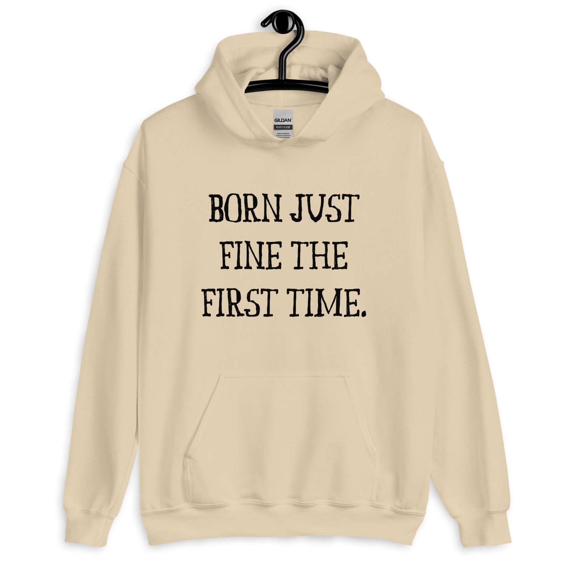 Sand color hoodie sweatshirt with the phrase Born just fine the first time printed on the front.