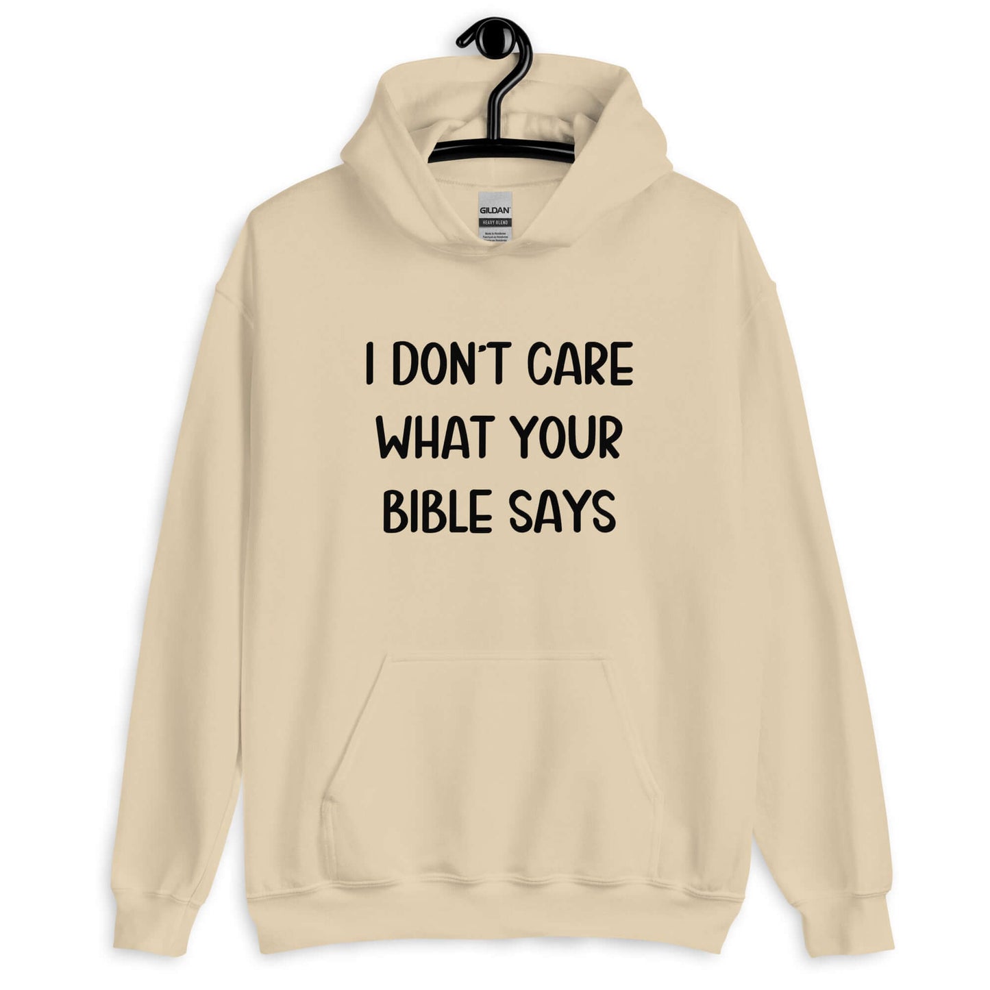 Sand color hoodie sweatshirt with the phrase I don't care what your bible says printed on the front.