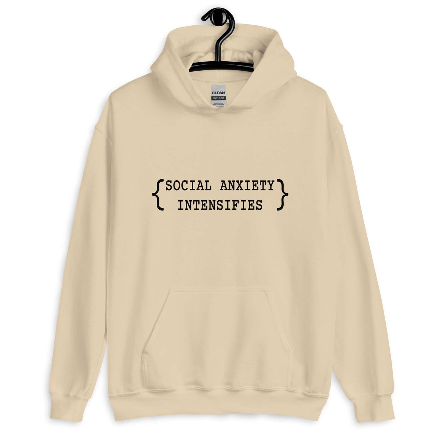 Sand color hoodie sweatshirt with the words Social anxiety intensifies printed on the front.