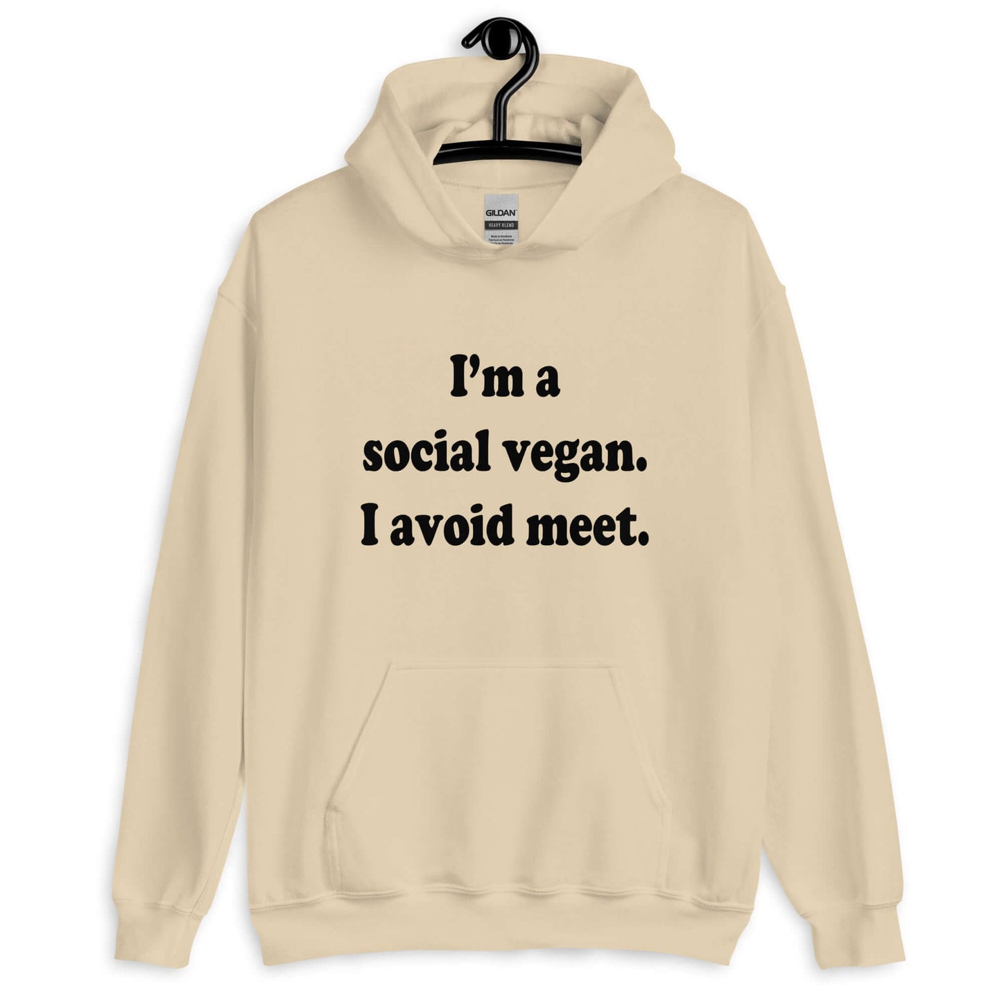 Sand hoodie sweatshirt with the pun phrase I'm a social vegan, I avoid meet printed on the front.