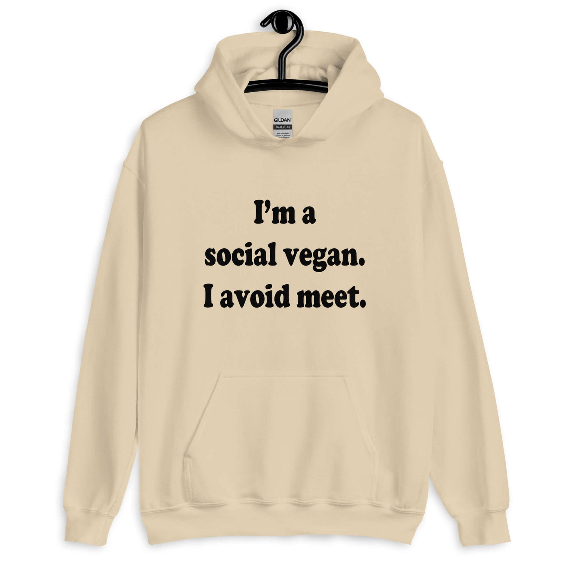 Sand hoodie sweatshirt with the pun phrase I'm a social vegan, I avoid meet printed on the front.