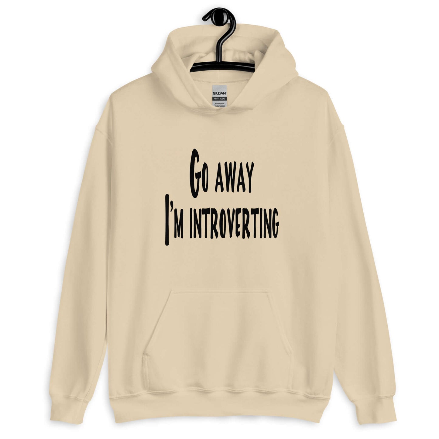 Sand color hoodie sweatshirt with the phrase Go away, I'm introverting printed on the front.