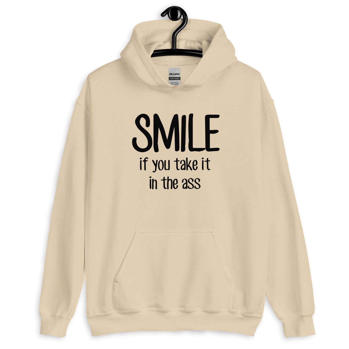 Sand hoodie sweatshirt with the phrase Smile if you take it in the ass printed on the front. The word smile is large and the words take it in the ass are much smaller.