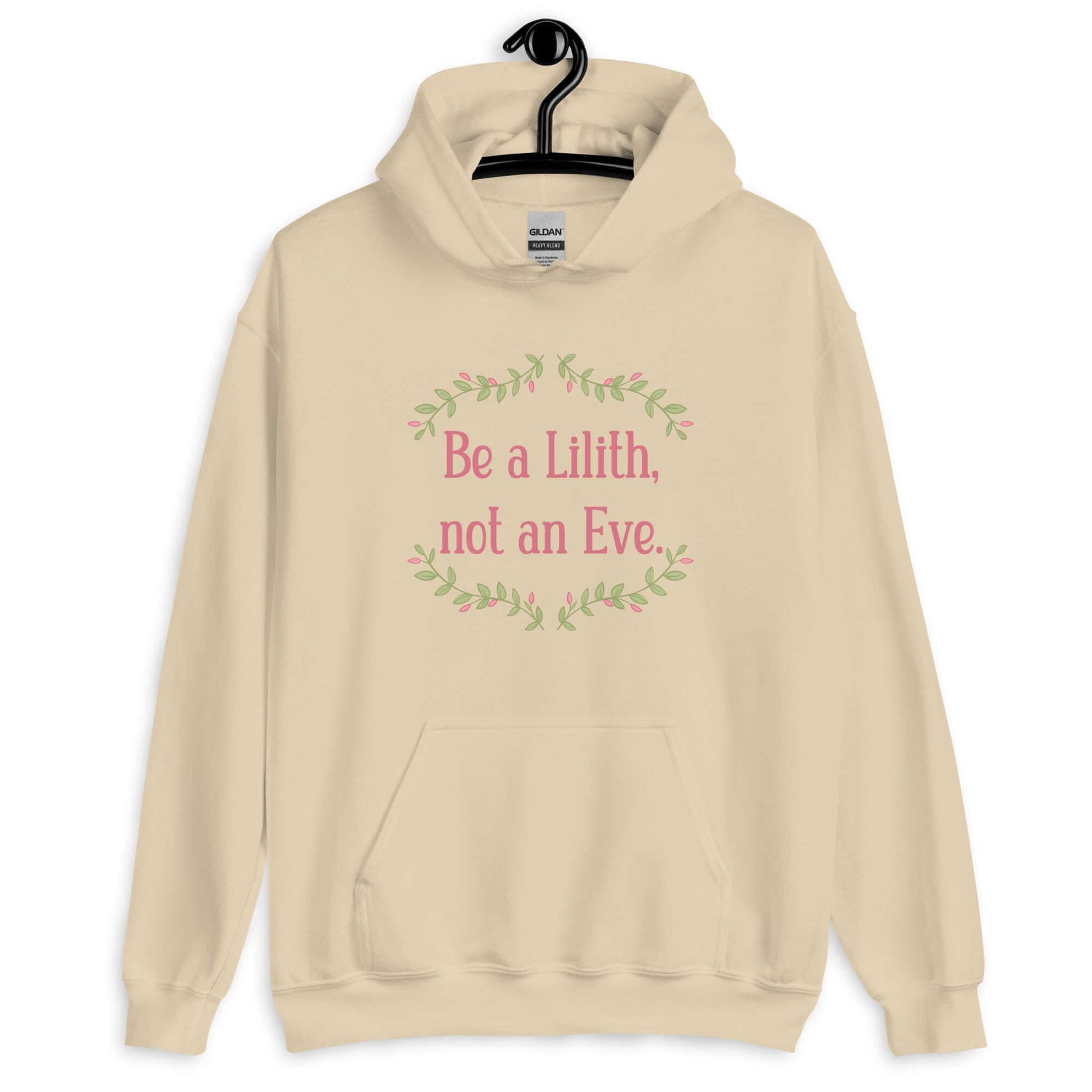 Sand color hoodie sweatshirt with the phrase Be a Lilith, not an Eve printed on the front. The text is pink and had a green floral vine graphic framing the text.