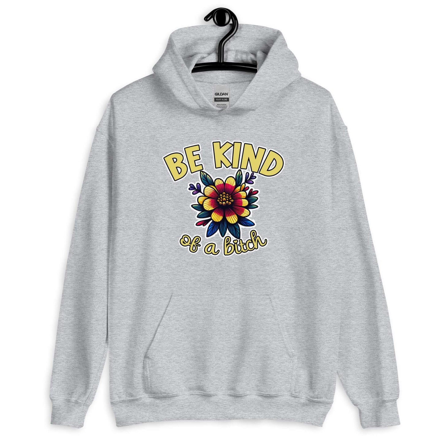 Light grey hoodie sweatshirt with an image of a flower and the words Be kind above the flower in yellow bold block font. The words Of a bitch are smaller in script font under the flower. The design is printed on the front of the hoodie.