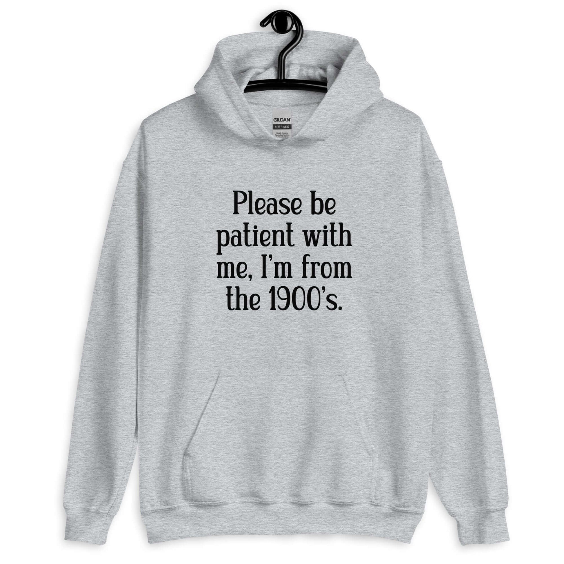 Sport grey hoodie sweatshirt with the phrase Please be patient with me, I'm from the 1900s printed on the front.