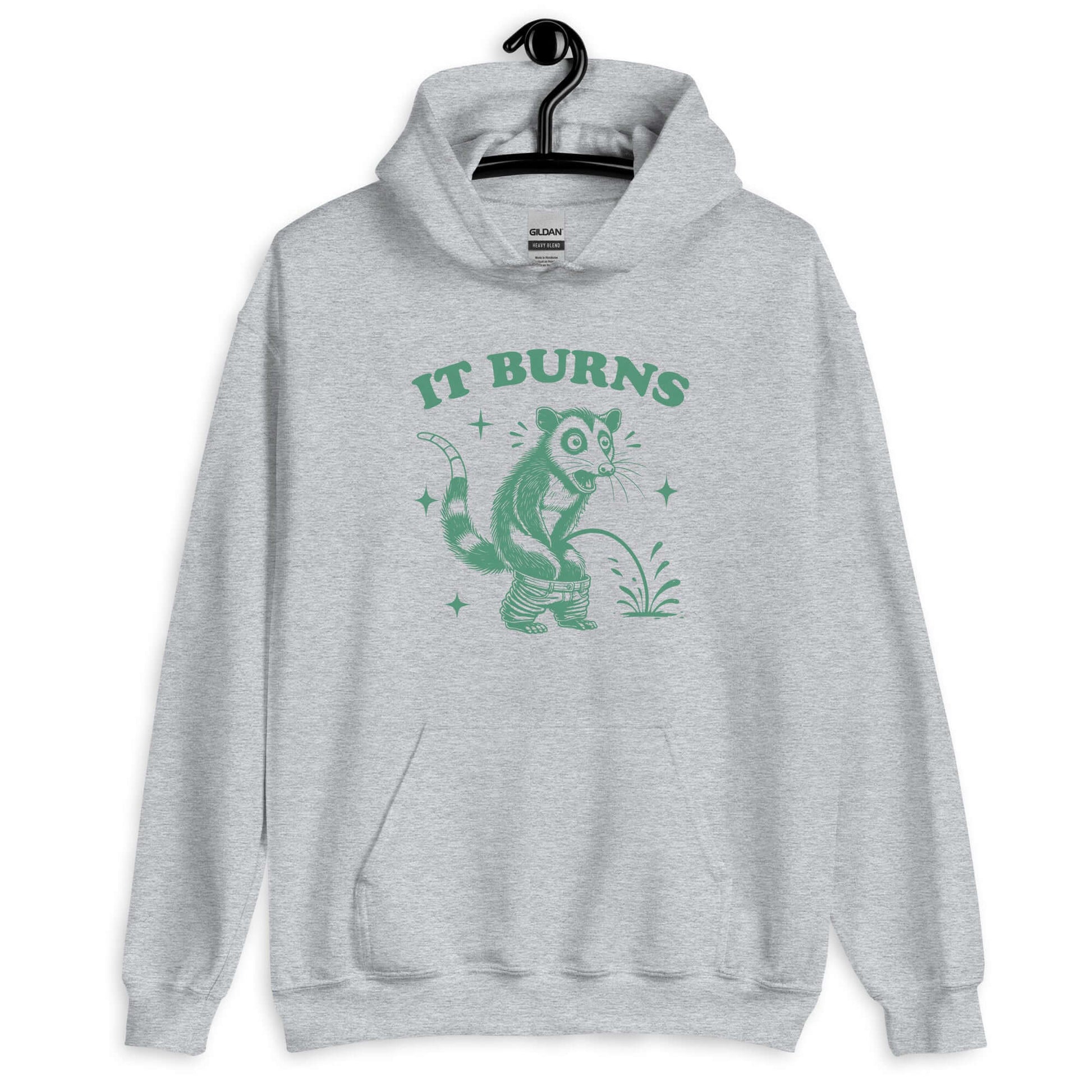 Sport grey hoodie sweatshirt with an image of an opossum peeing. The words It burns are printed above.