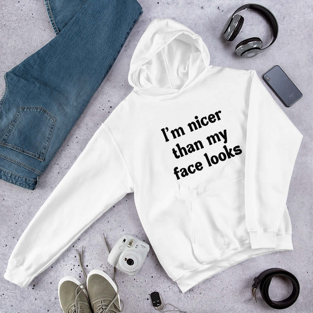 White hoodie sweatshirt that says I'm nicer than my face looks printed on the front.