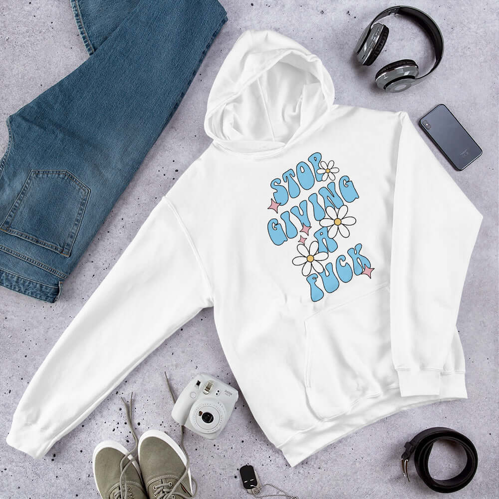 White hoodie sweatshirt with stop giving a fuck printed on the front.