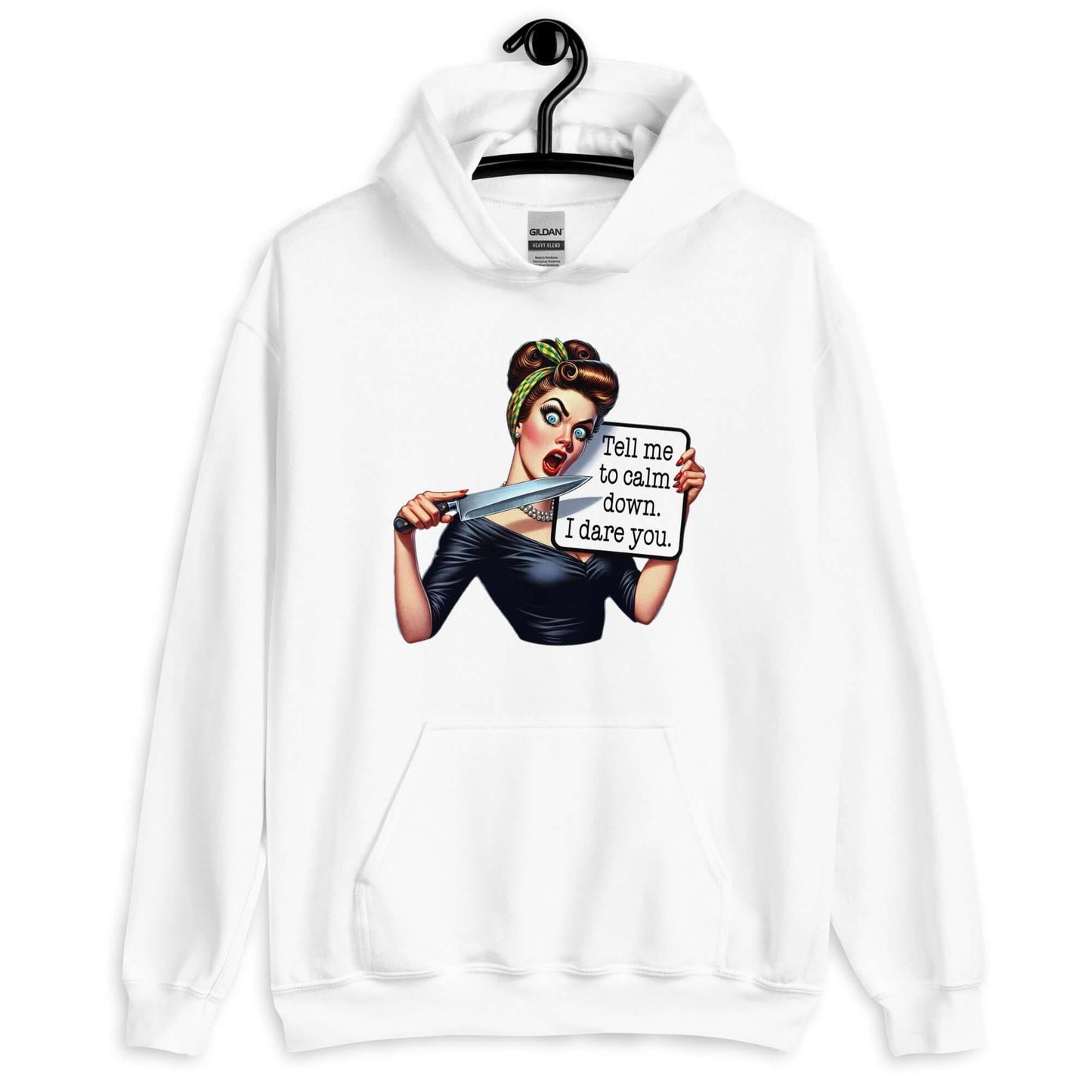 White hooded sweatshirt displayed on a hanger. The sweatshirt has a graphic of an angry looking retro woman holding a knife and a sign. The sign says Tell me to calm down I dare you. The graphic is printed on the front of the hoodie.