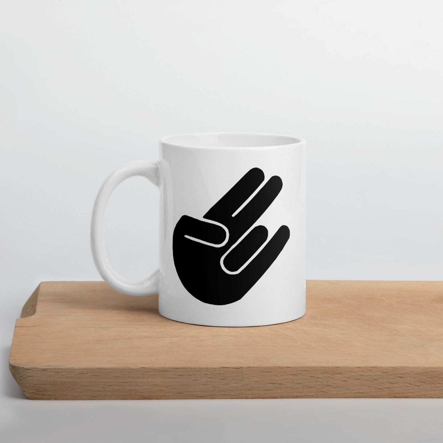 White ceramic coffee mug with the universal hand symbol for The Shocker printed on both sides of the mug.