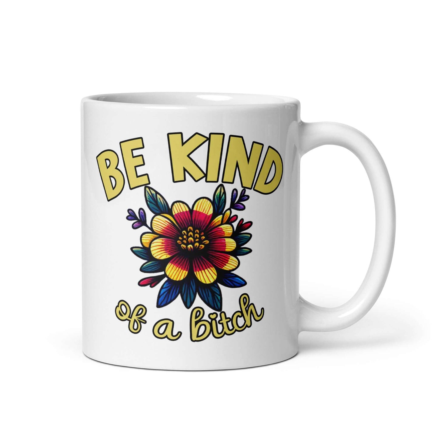 White ceramic coffee mug with an image of a flower and the words Be kind above the flower in bold block font. The words Of a bitch are smaller in script font under the flower. The design is printed on both sides of the mug.