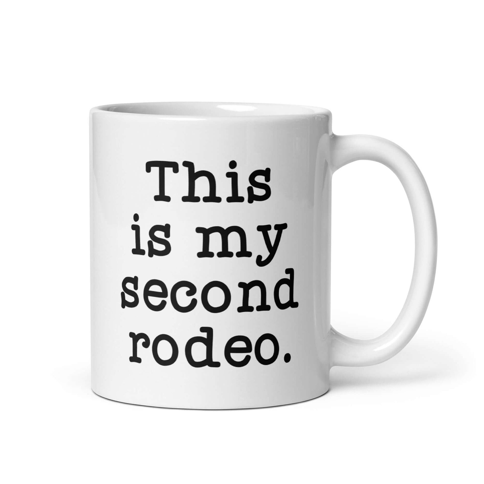 White ceramic mug with the funny phrase This is my second rodeo printed on both sides of the mug.