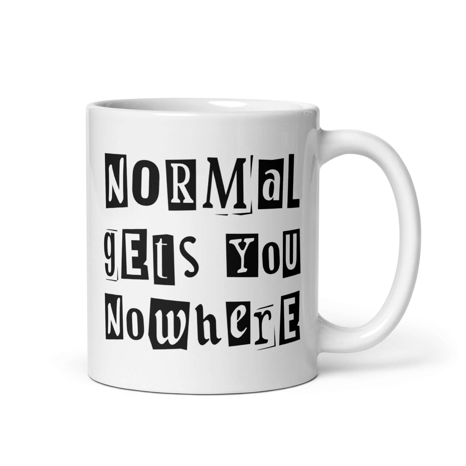 11 ounce white ceramic coffee mug with the phrase Normal gets you nowhere printed on both sides.