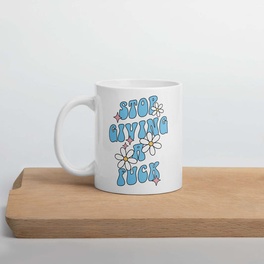 White ceramic coffee mug with stop giving a fuck printed on both sides.