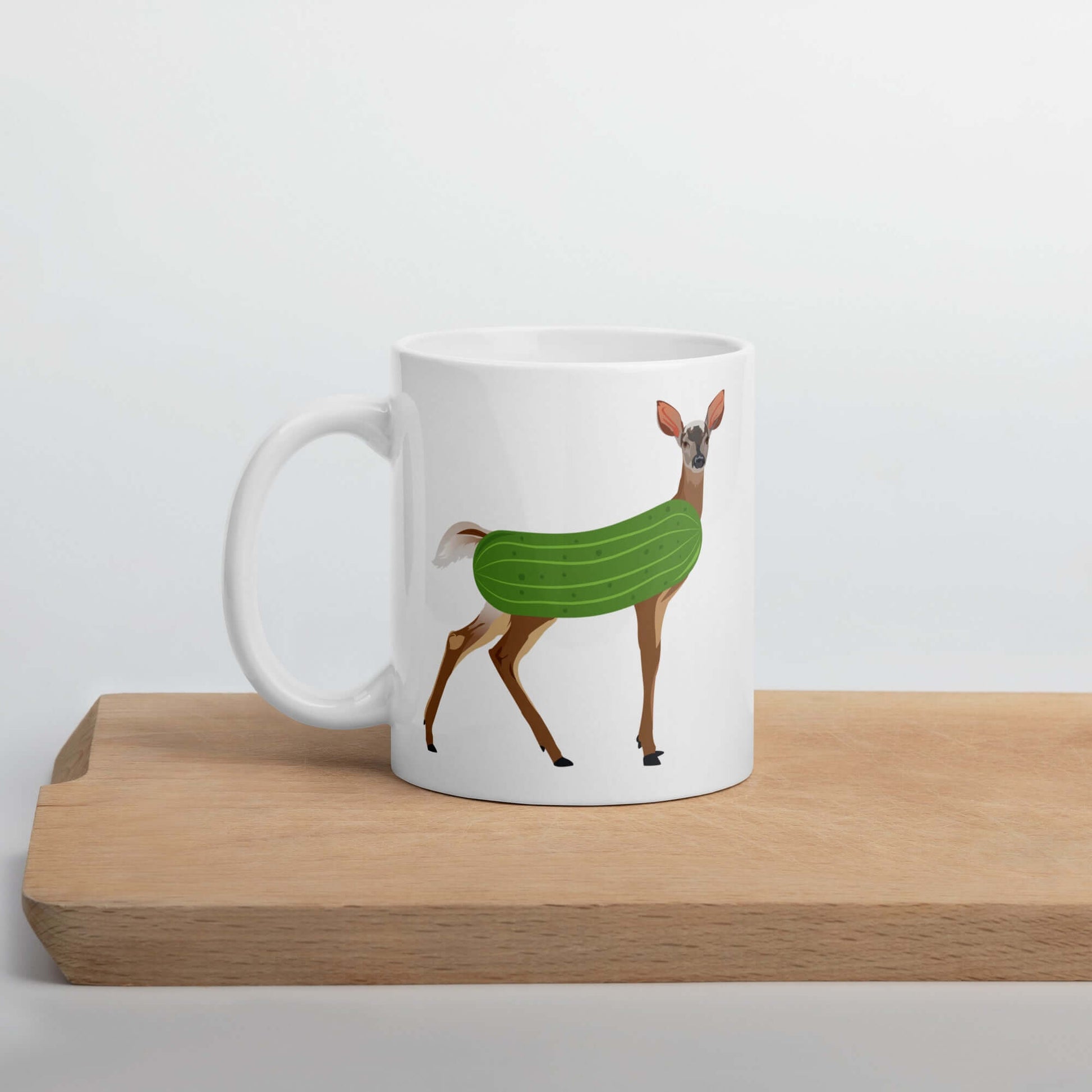 White ceramic dildo pun coffee mug with funny image of a doe deer with a dill pickle body.