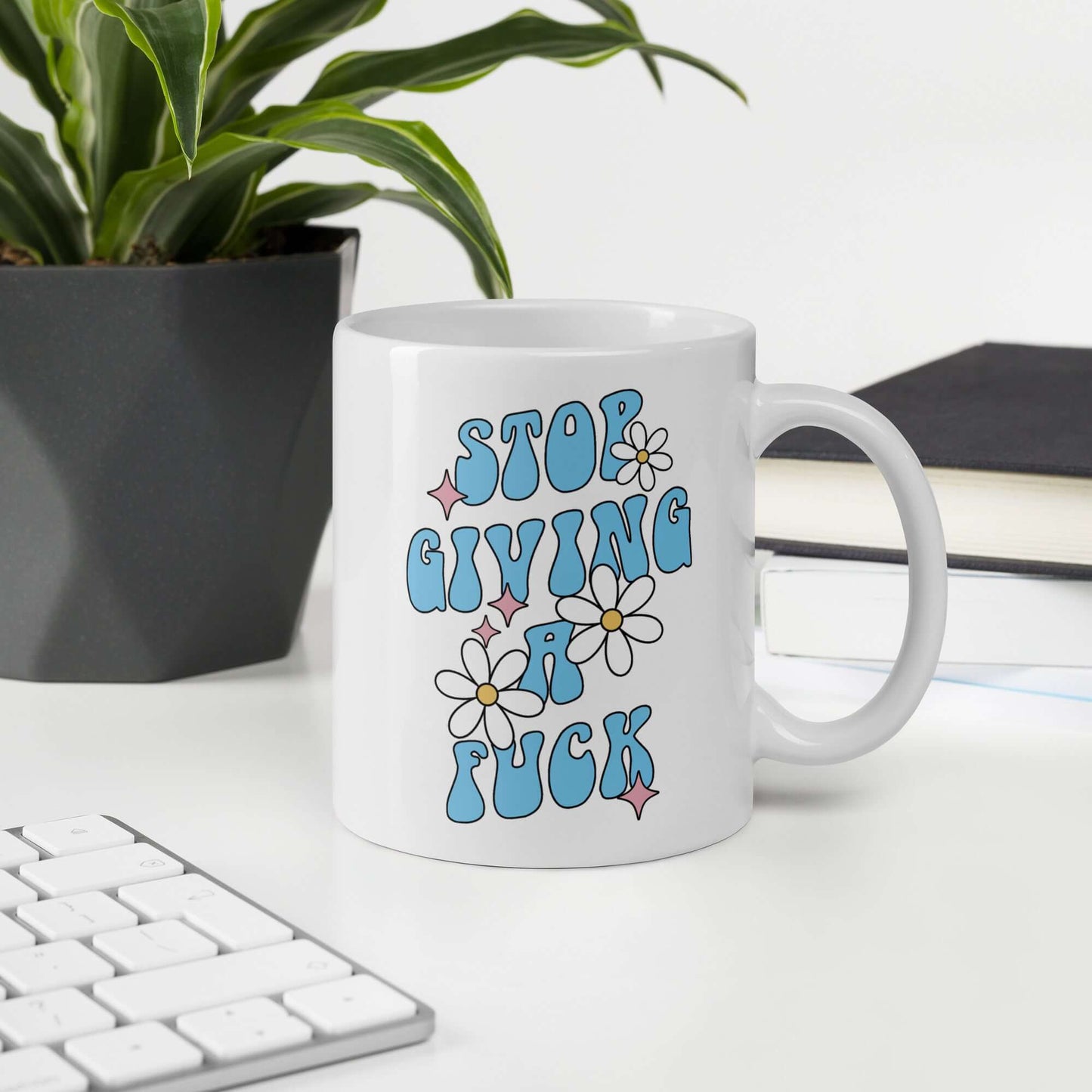 White ceramic coffee mug with stop giving a fuck printed on both sides.