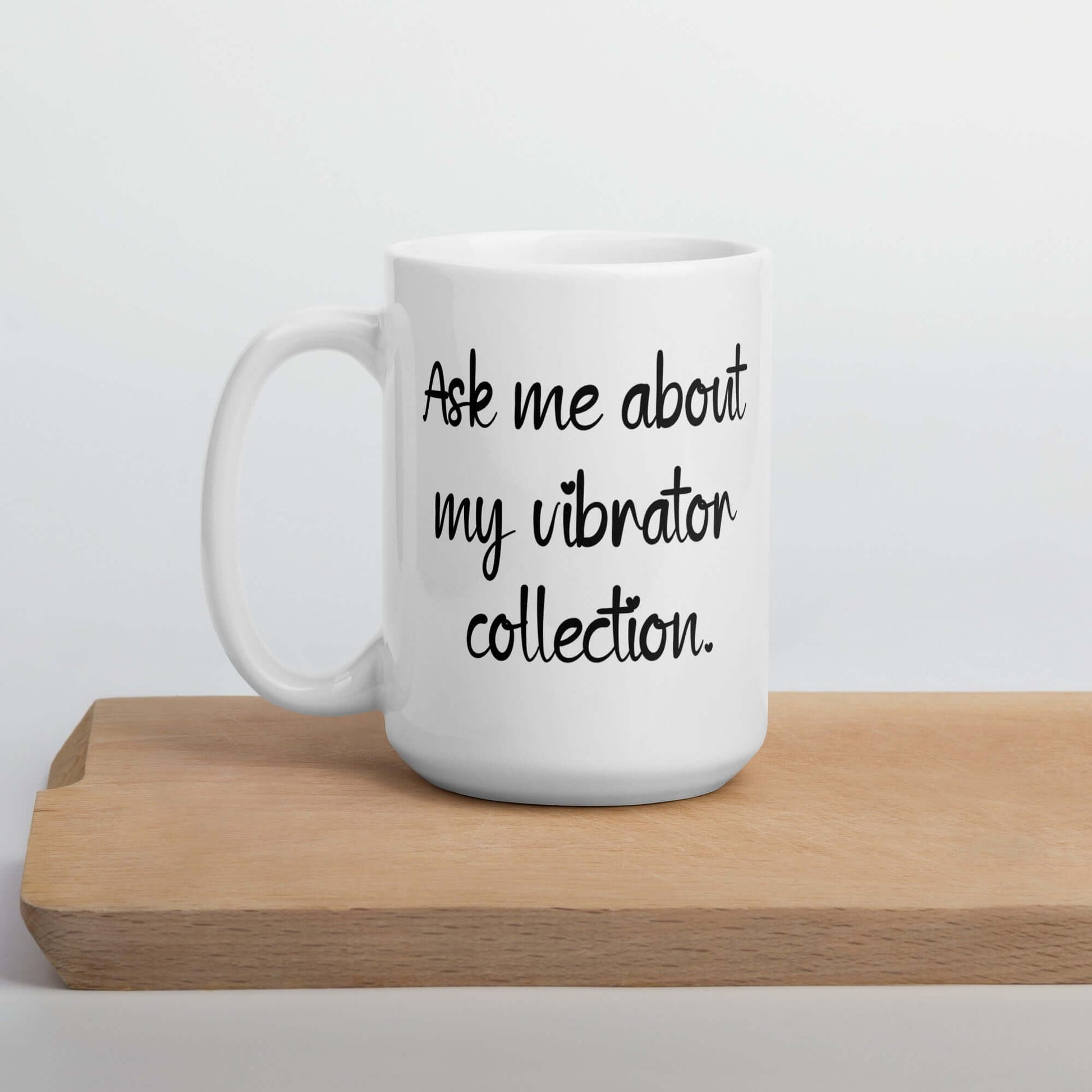 White ceramic mug with the phrase Ask me about my vibrator collection printed on both sides of the mug.