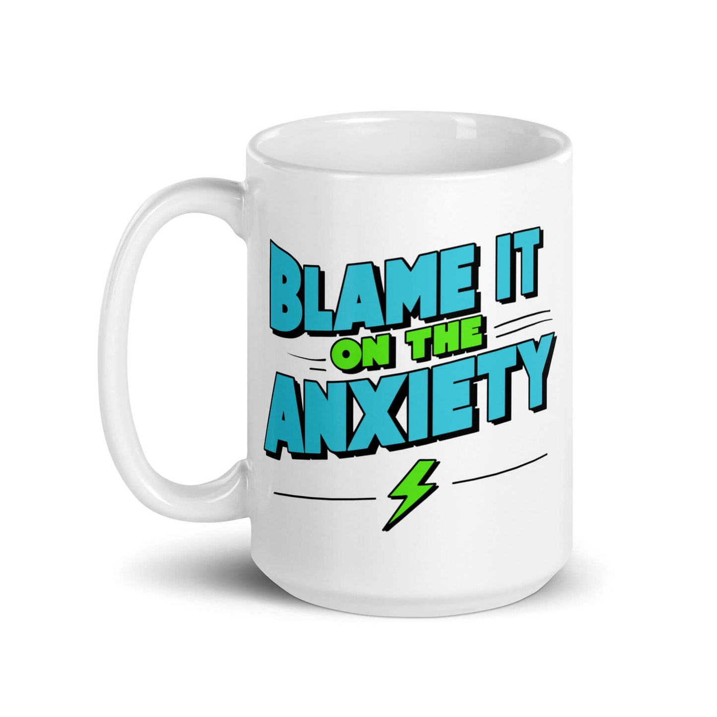 White ceramic mug with the phrase Blame is on the anxiety printed on both sides. The graphics are bold and in aqua and lime green.