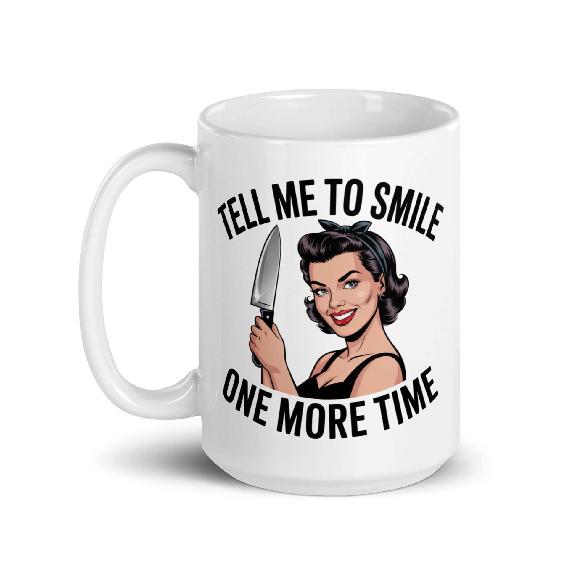 White ceramic mug with graphic of a woman holding a knife and the phrase 'Tell me to smile one more time'. 