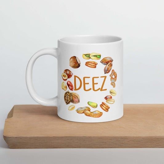 White ceramic mug with an image of various nuts and the word Deez. The graphic is printed on both sides of the mug.