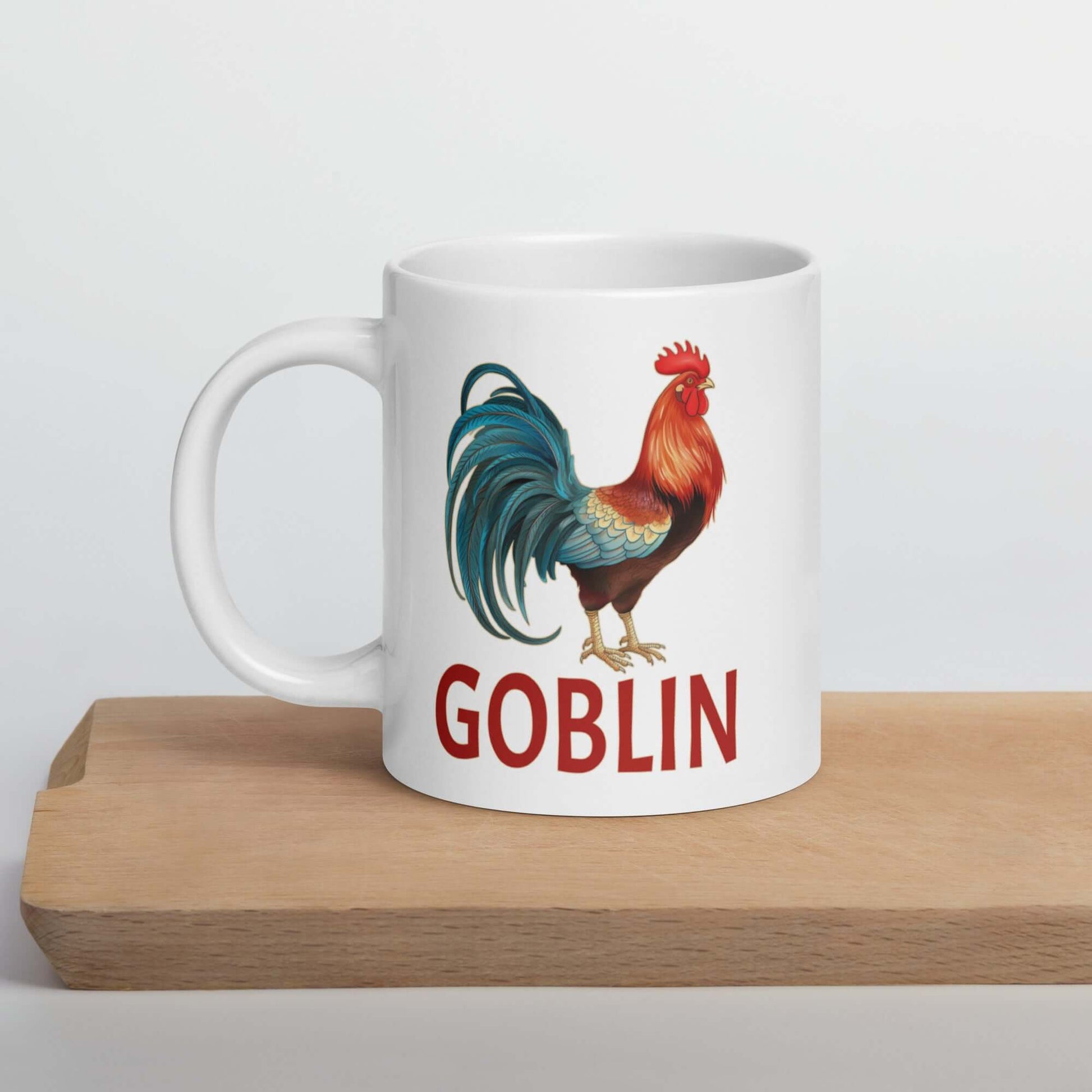 White ceramic coffee mug with image of a rooster and the word goblin under.