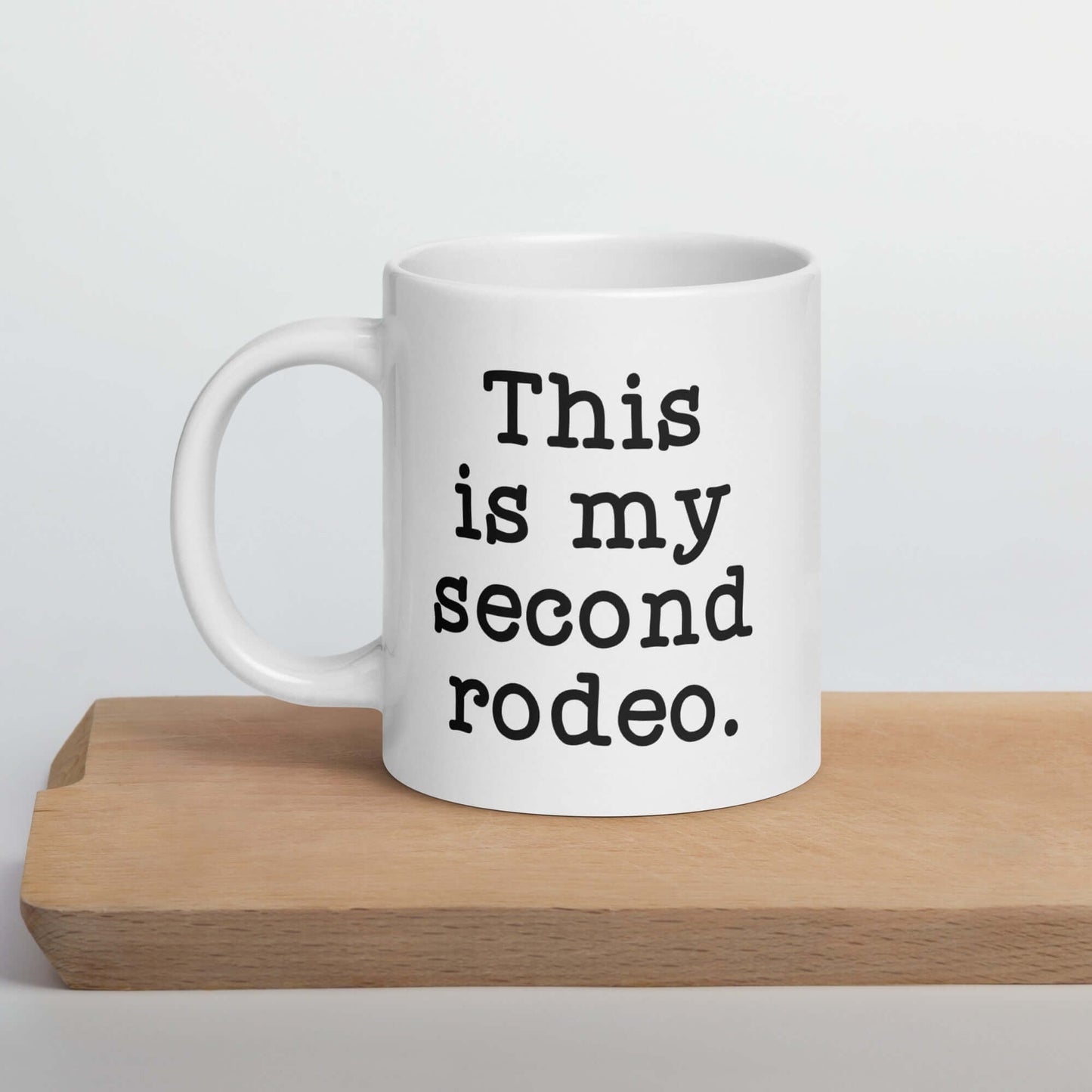 White ceramic mug with the funny phrase This is my second rodeo printed on both sides of the mug.