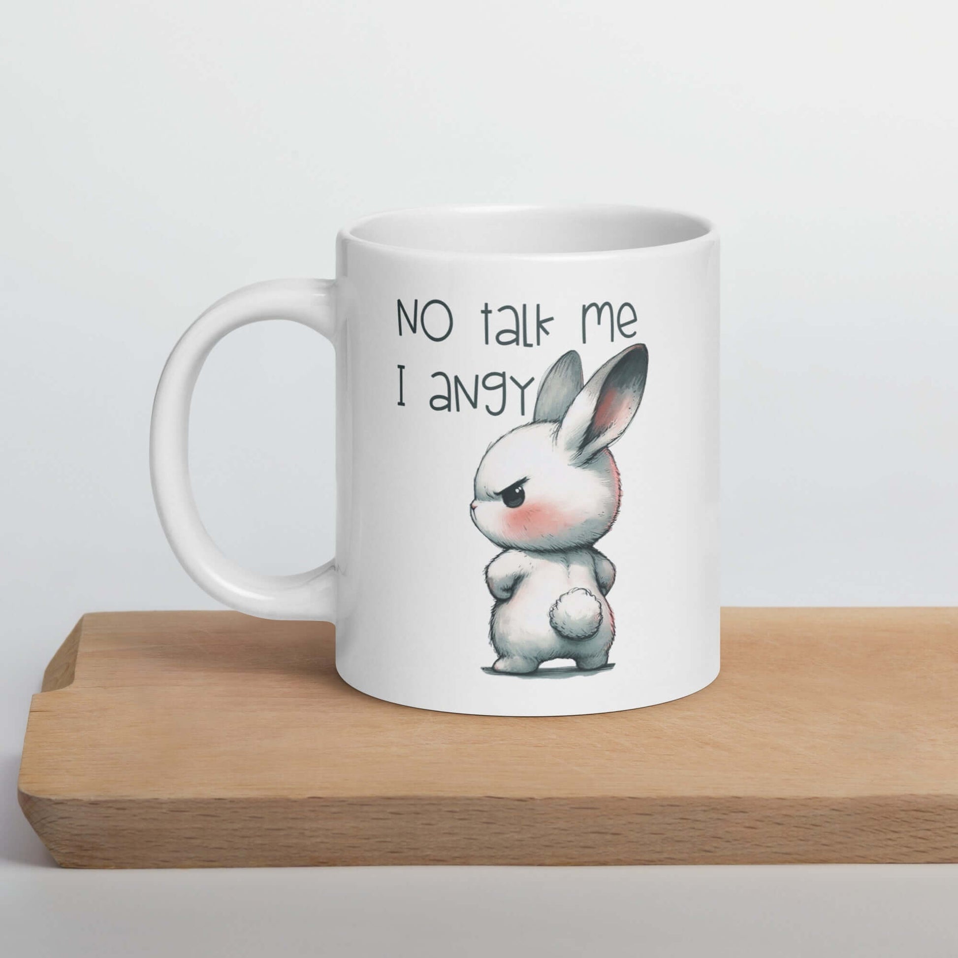 20 oz ceramic coffee mug with an image of an angry bunny with the phrase No talk me I angy printed on both sides of the mug.