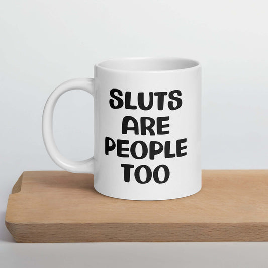 White ceramic mug with the phrase Sluts are people too printed on both sides.