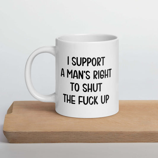 White mug with black text on a wooden surface