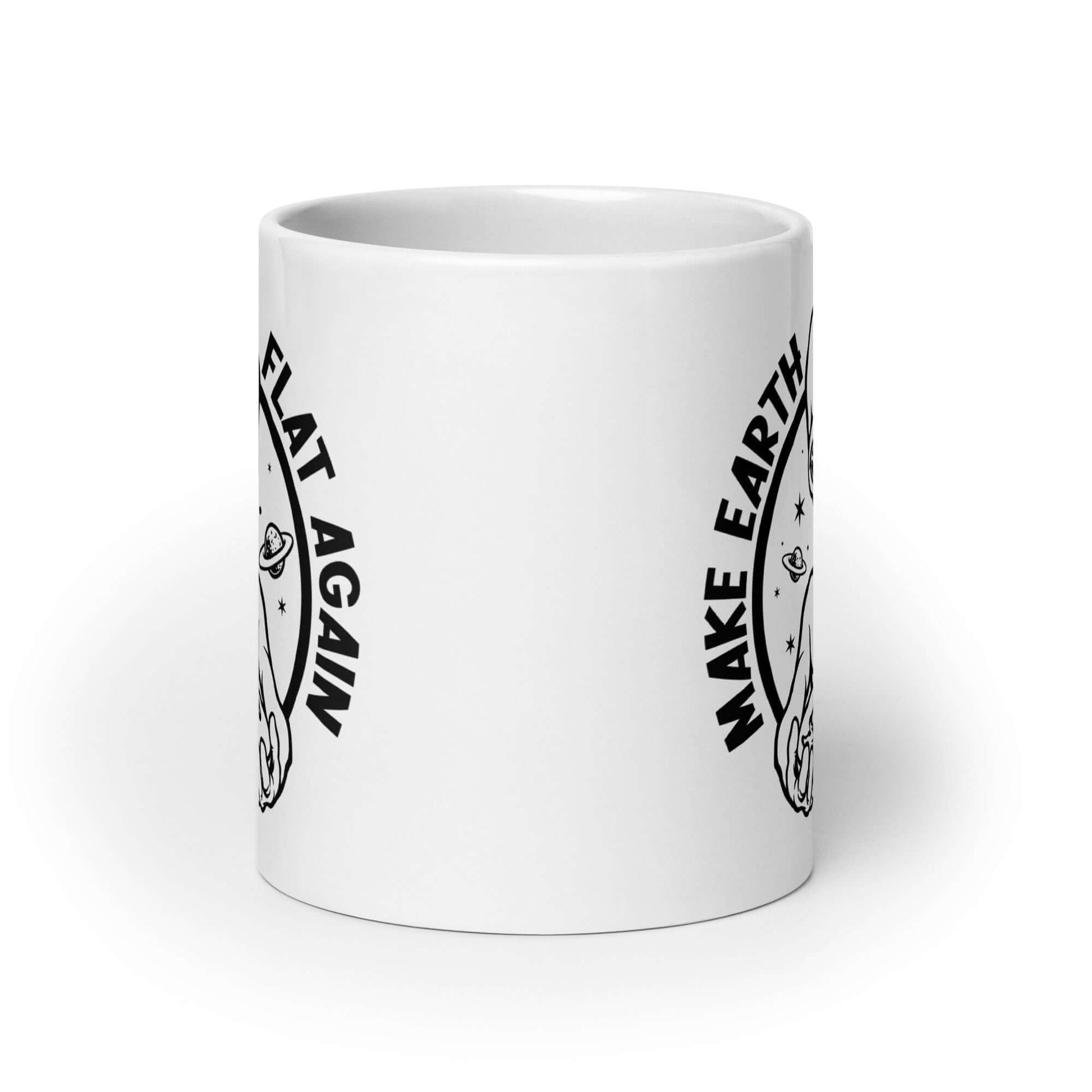 White ceramic coffee mug with an image of an alien holding flat earth and the phrase Make earth flat again printed on both sides.