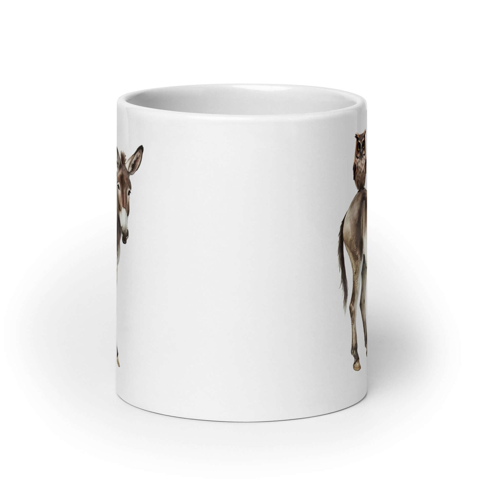 White ceramic coffee mug with an image of a donkey with wise owl sitting on it printed on both sides of the mug.
