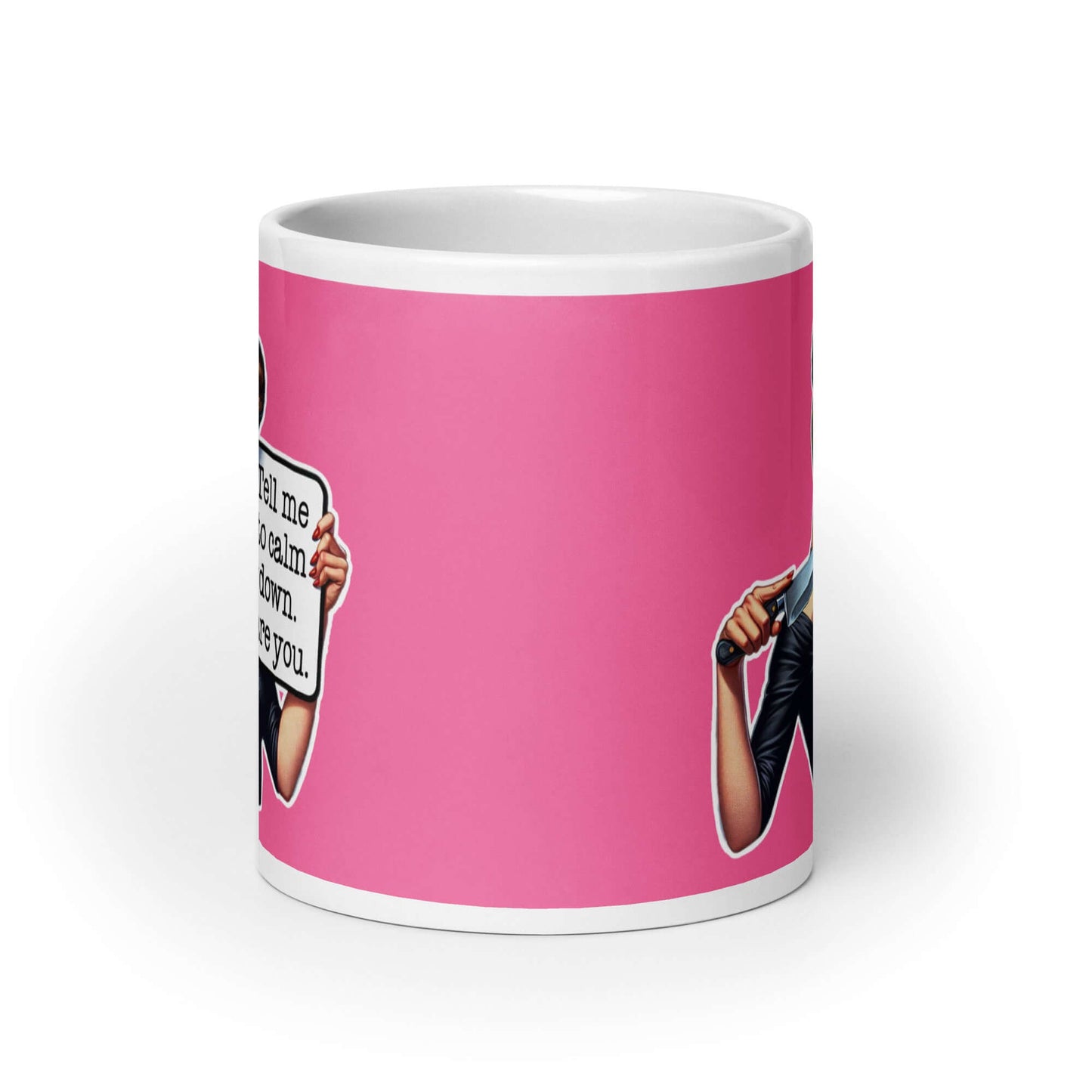 White ceramic coffee mug with pink color wrapped around. The mug has a graphic of an angry looking retro woman holding a knife and a sign. The sign says Tell me to calm down I dare you. The graphic is printed on both sides of the mug.