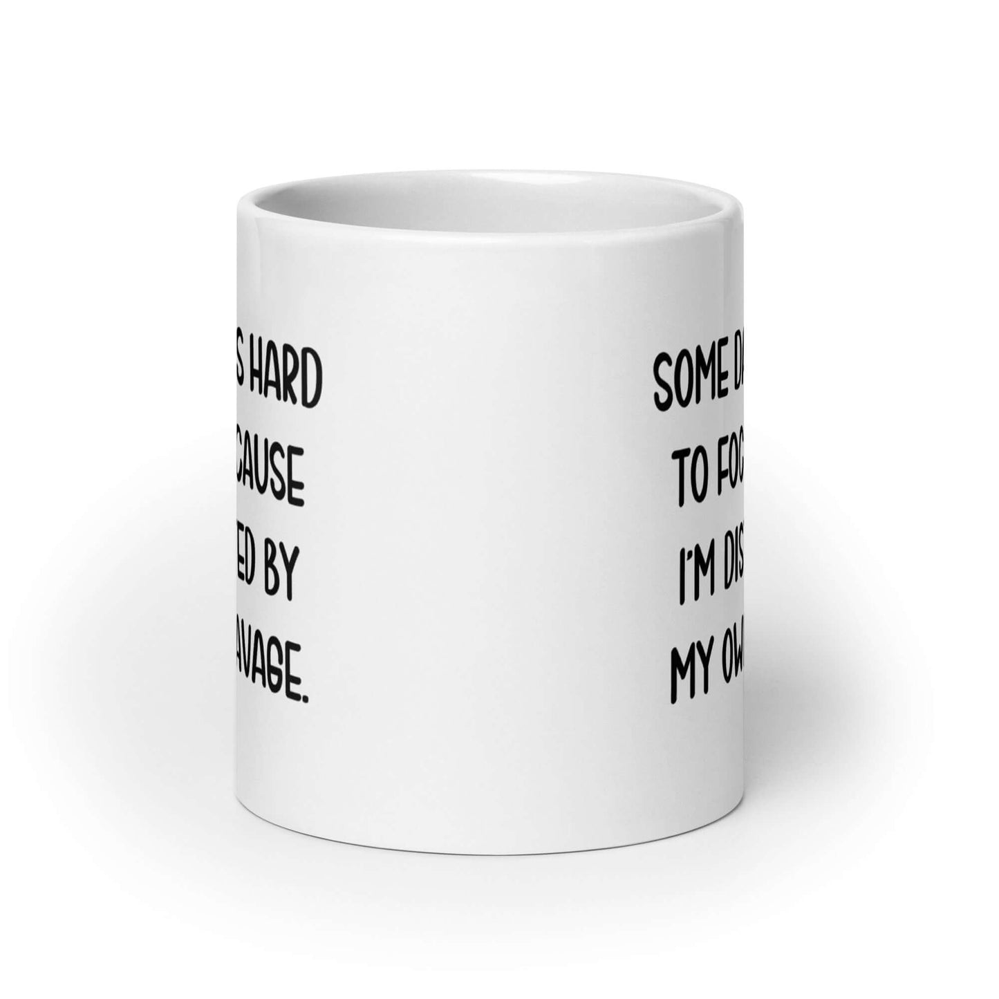 White ceramic mug with the phrase Some days it's hard to focus because I'm distracted by my own cleavage printed on both sides.