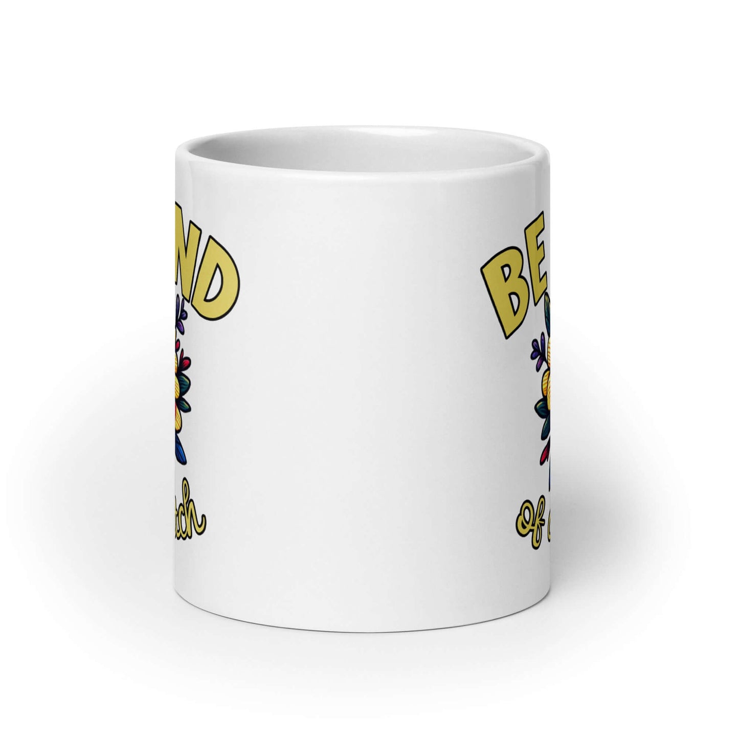 White ceramic coffee mug with an image of a flower and the words Be kind above the flower in bold block font. The words Of a bitch are smaller in script font under the flower. The design is printed on both sides of the mug.