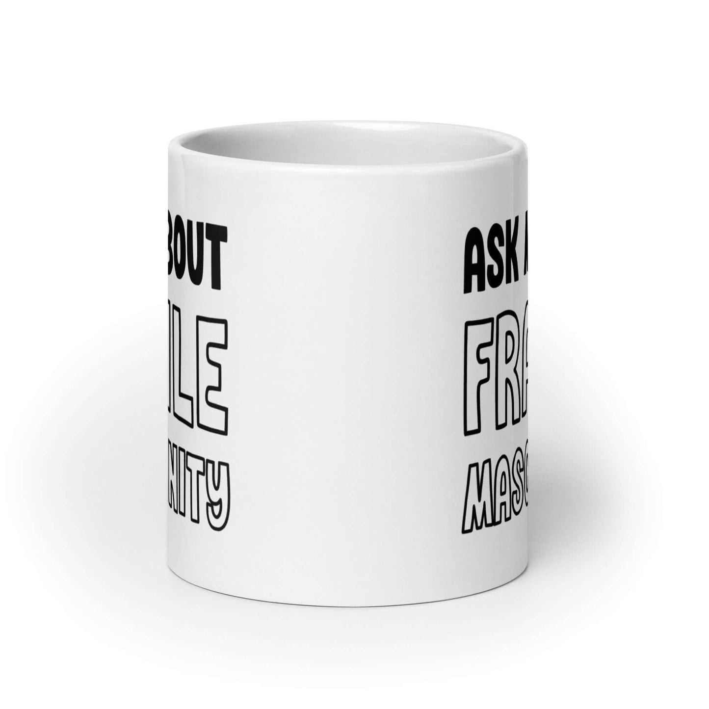 White ceramic mug with the phrase Ask me about fragile masculinity printed on both sides of the mug.