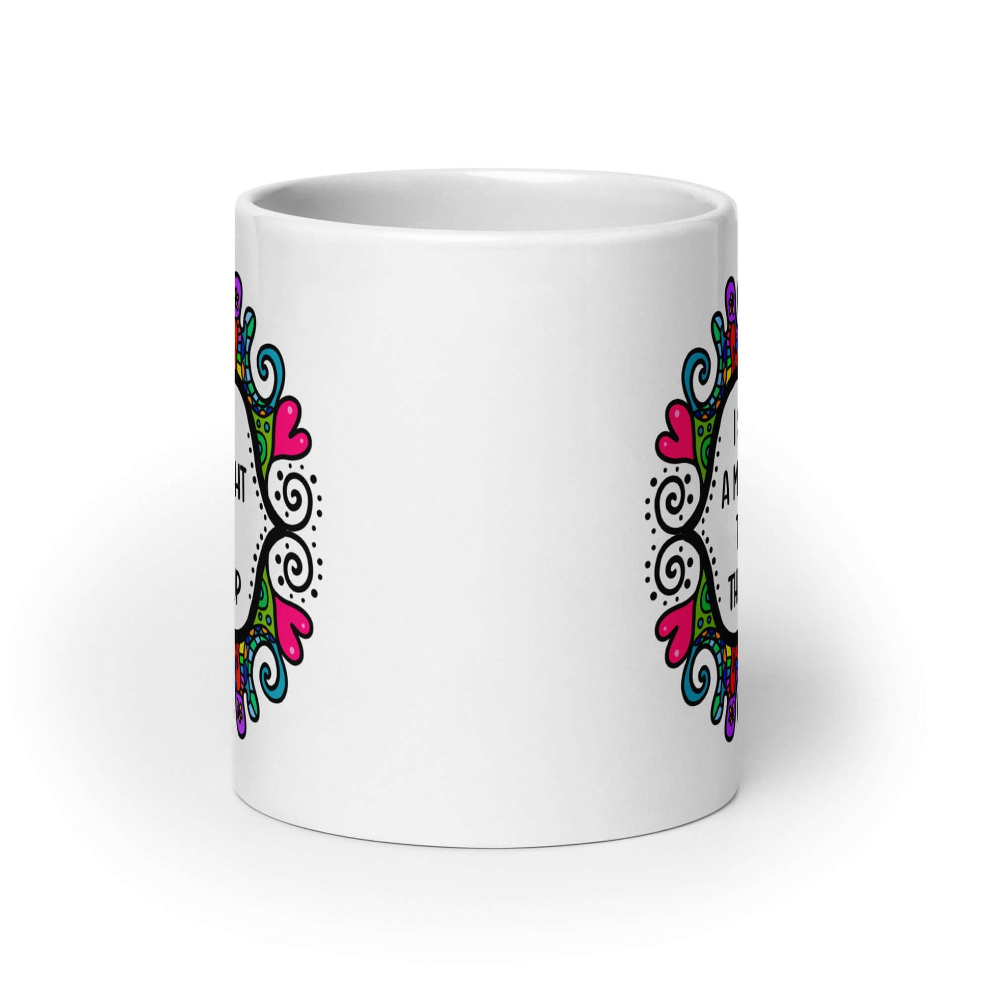 White ceramic mug with a colorful doodle graphic and the words I support a man's right to shut the hell up. The design is printed on both sides of the mug.