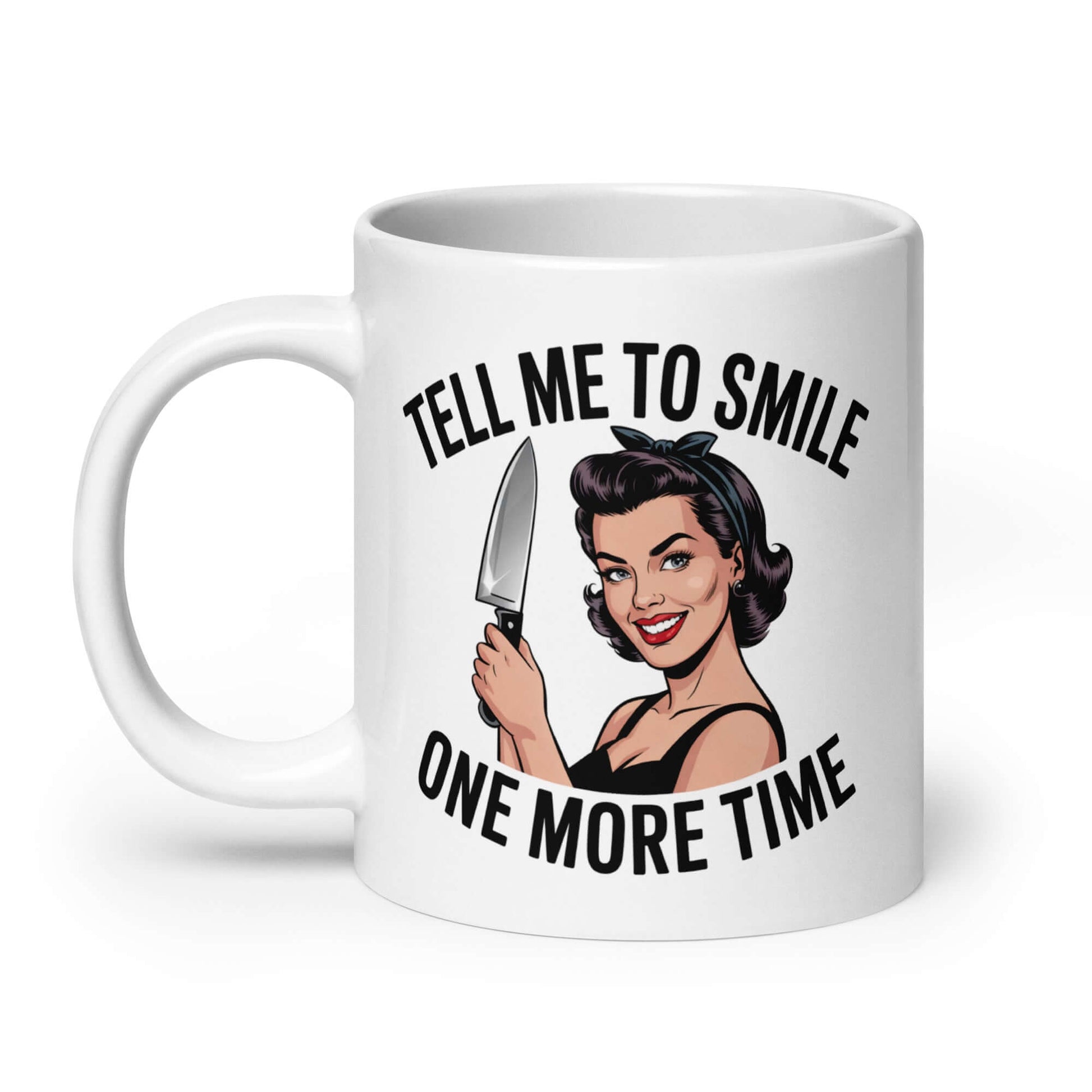 White ceramic mug with graphic of a woman holding a knife and the phrase 'Tell me to smile one more time'. 