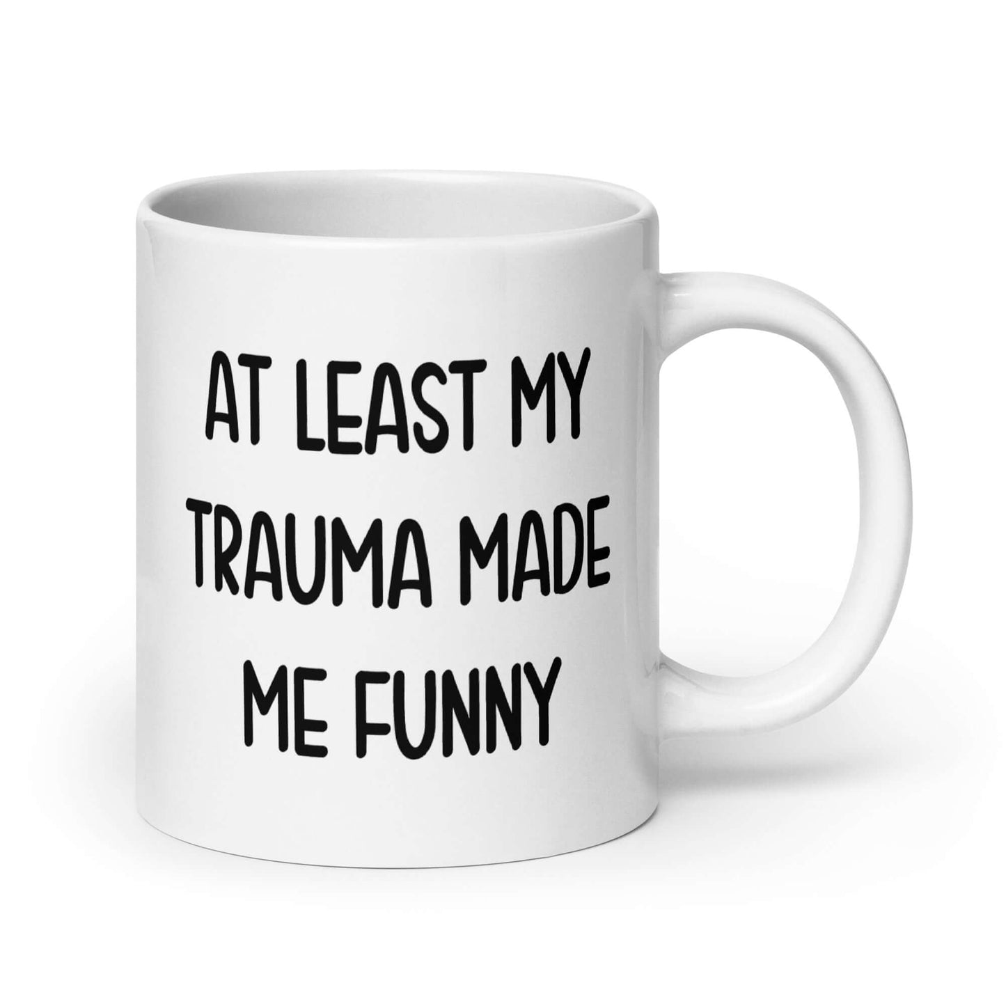 White ceramic mug with the words At least my trauma made me funny printed on both sides.