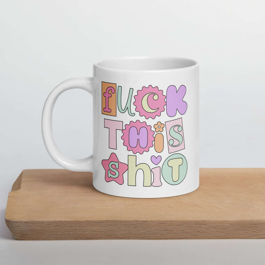 White ceramic coffee mug with colorful pastel font Fuck this shit graphics printed on both sides.