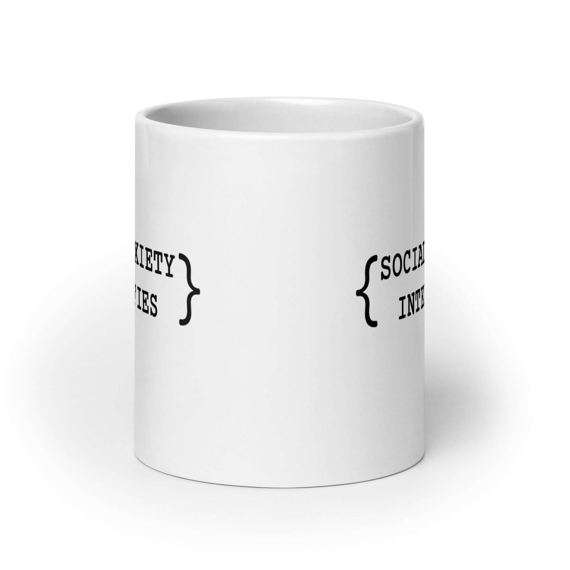 White ceramic coffee mug with the words Social anxiety intensifies printed on both sides.