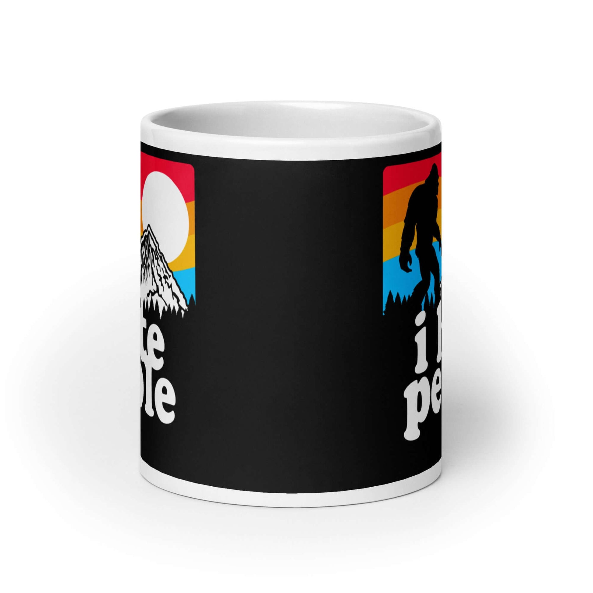 White coffee mug with graphic of Bigfoot walking into the sunset with the words I hate people printed on both sides. 