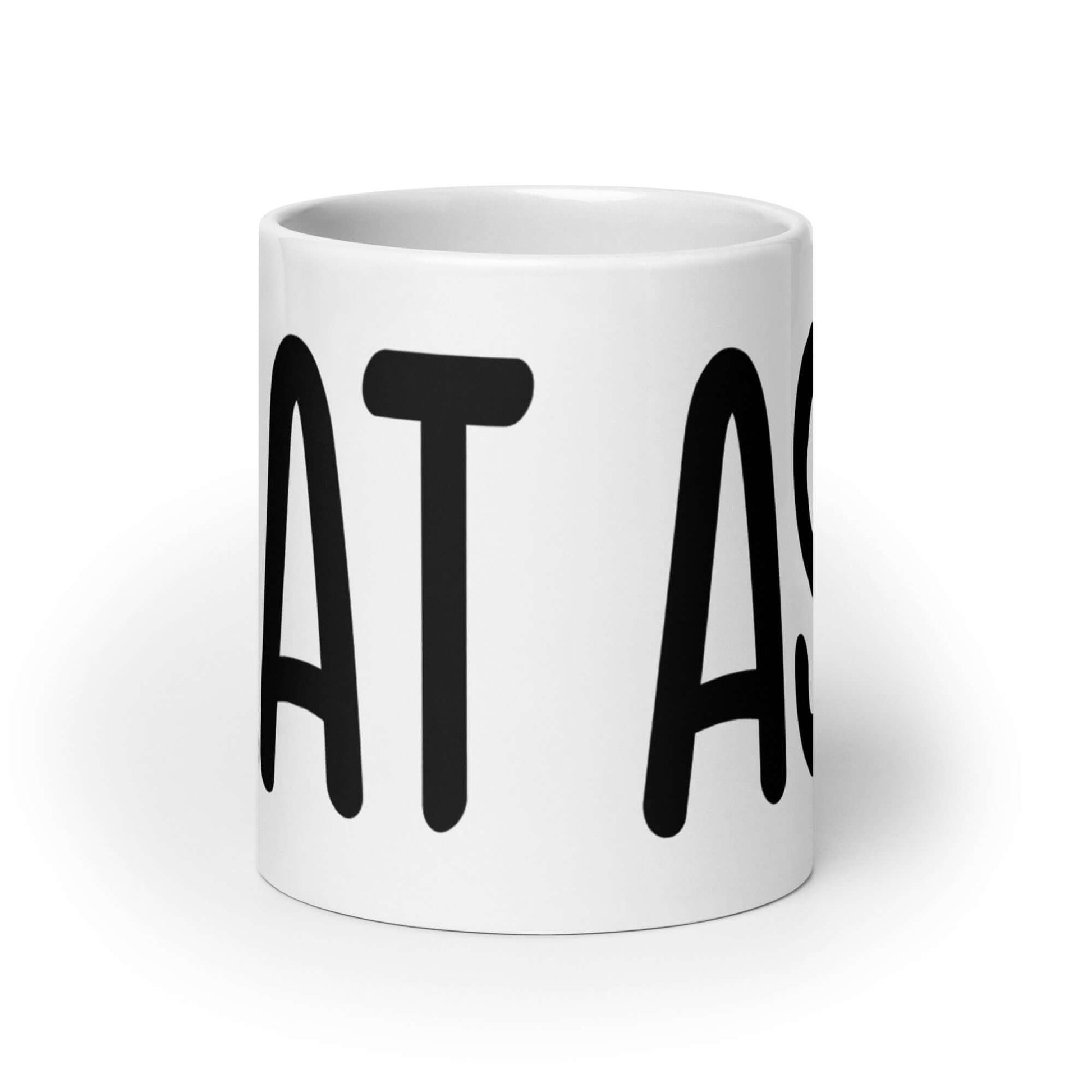 White ceramic coffee mug with the words I eat ass printed on it. The words are large and wrap all around the mug.