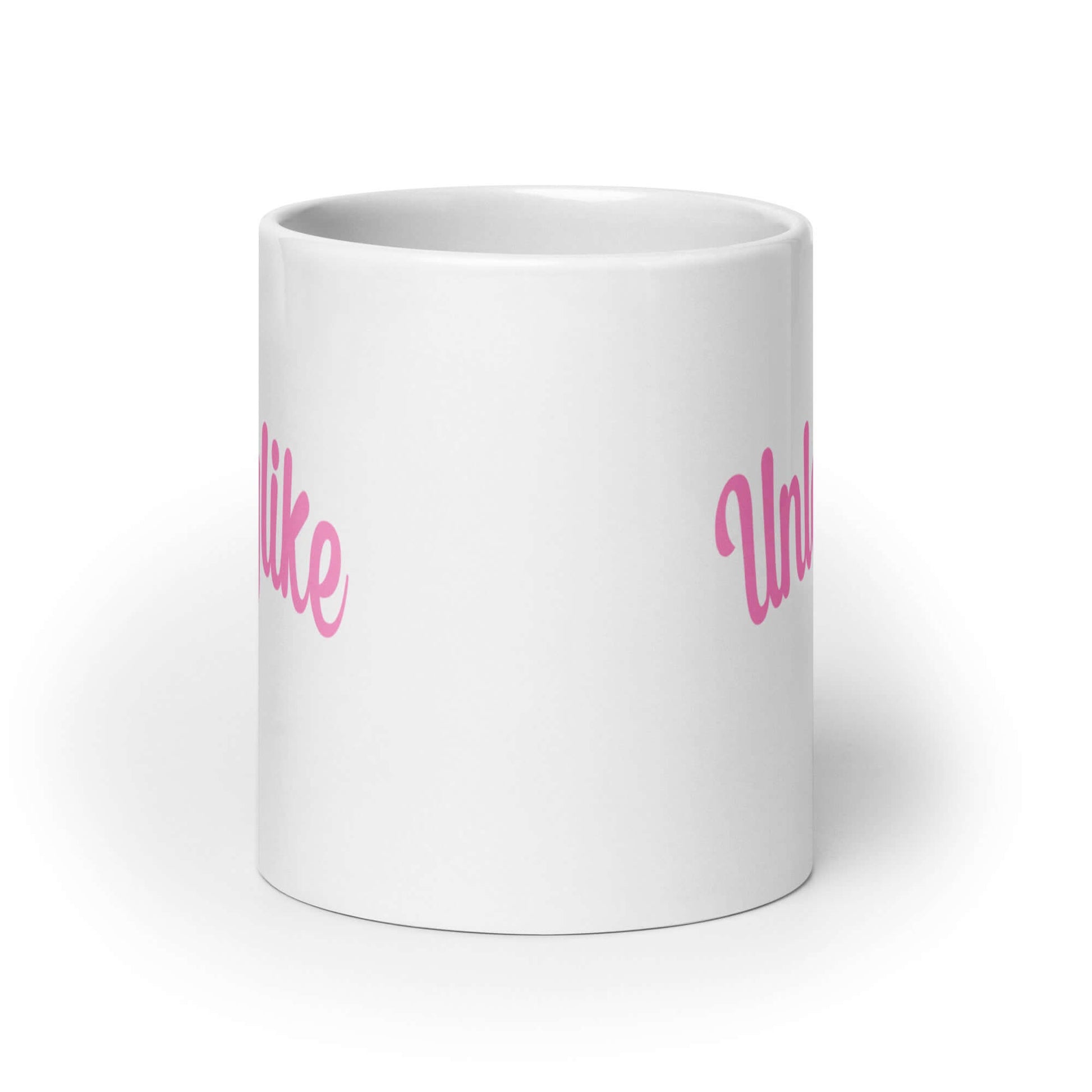 White ceramic coffee mug with the word Unladylike printed in pink on both sides.