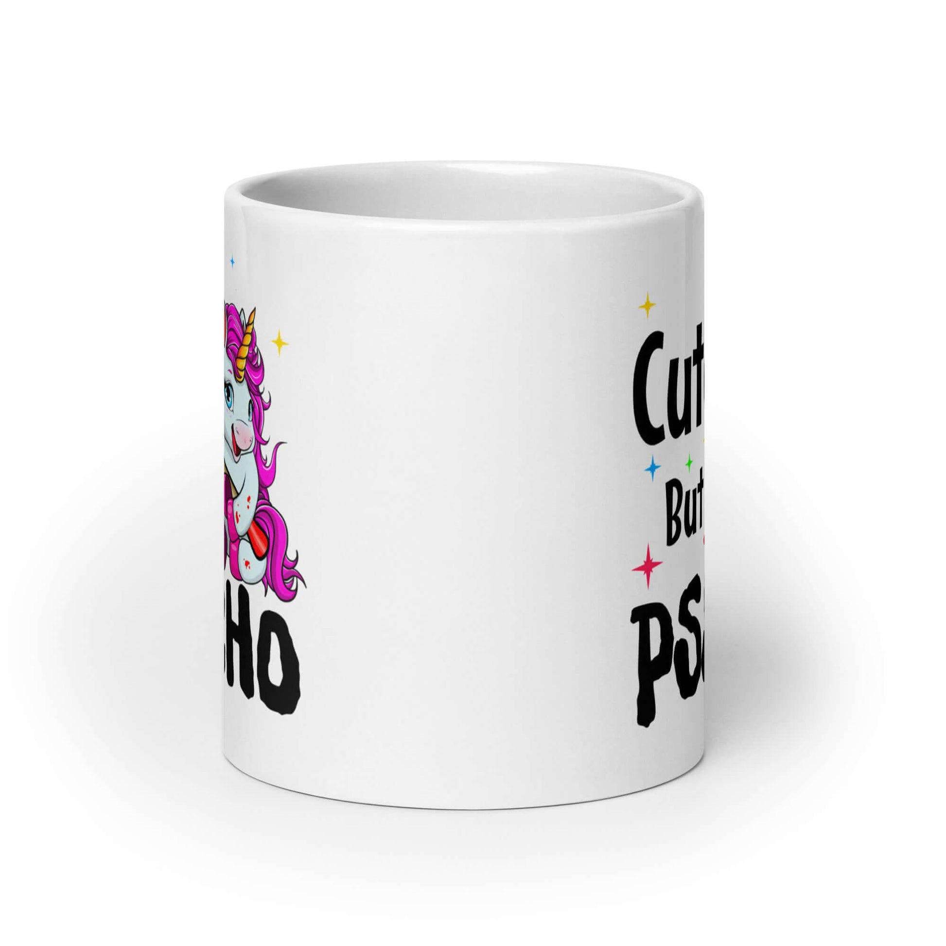 White ceramic coffee mug that has a graphic of a unicorn holding a knife & the words Cute but psycho printed on both sides.