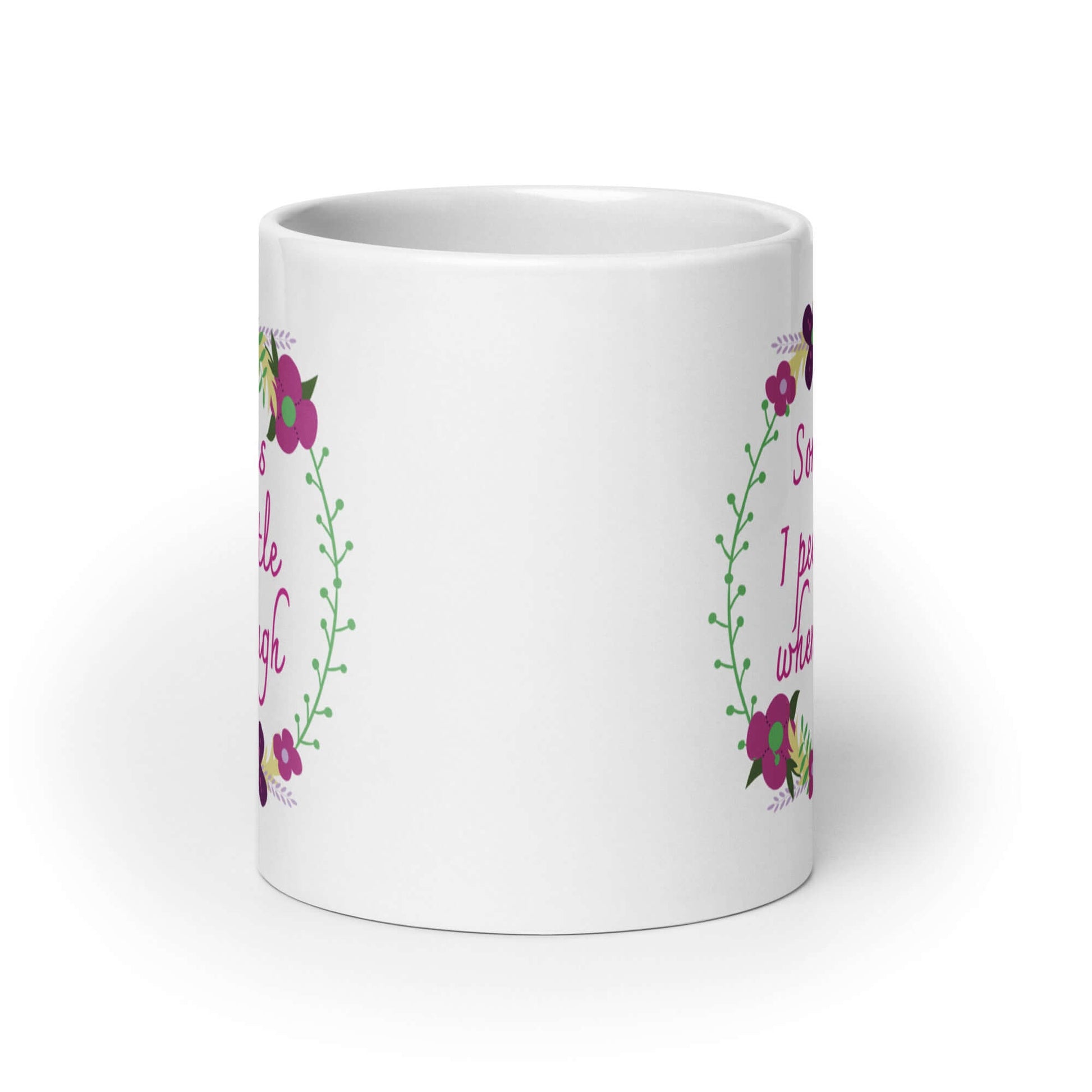 White ceramic coffee mug that has a minimalistic style line drawing floral wreath with the phrase Sometimes I pee a little when I laugh printed in the center of the wreath. The graphics are printed on both sides of the mug.